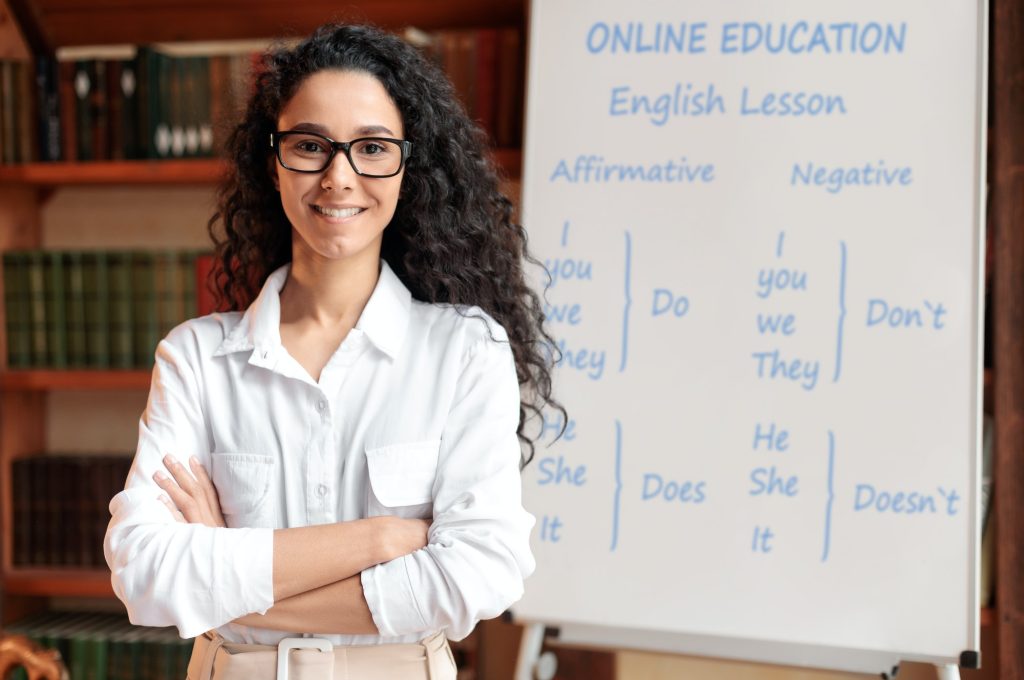 english-teacher-standing-at-board-posing-at-camera.jpg